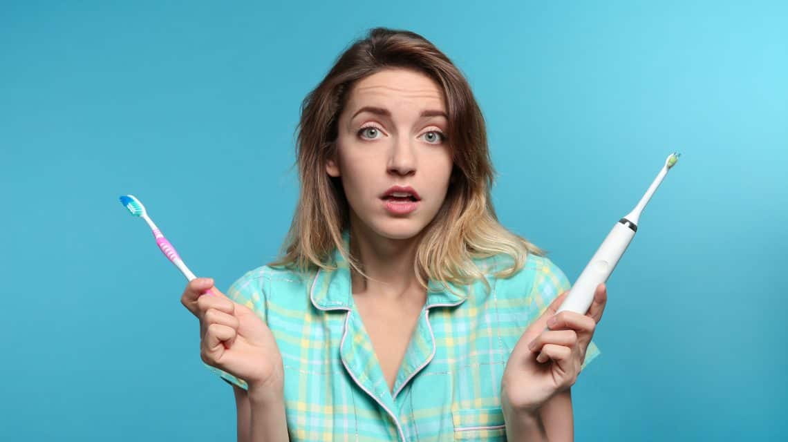 lady holding toothbrushes
