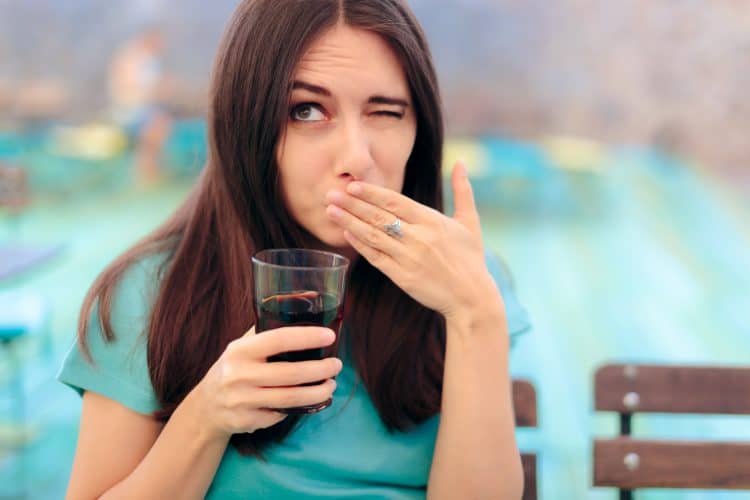 a lady consuming drinks with sugar and acid